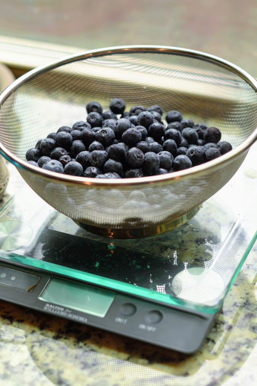 Blueberries in a strainer on a kitchen scale